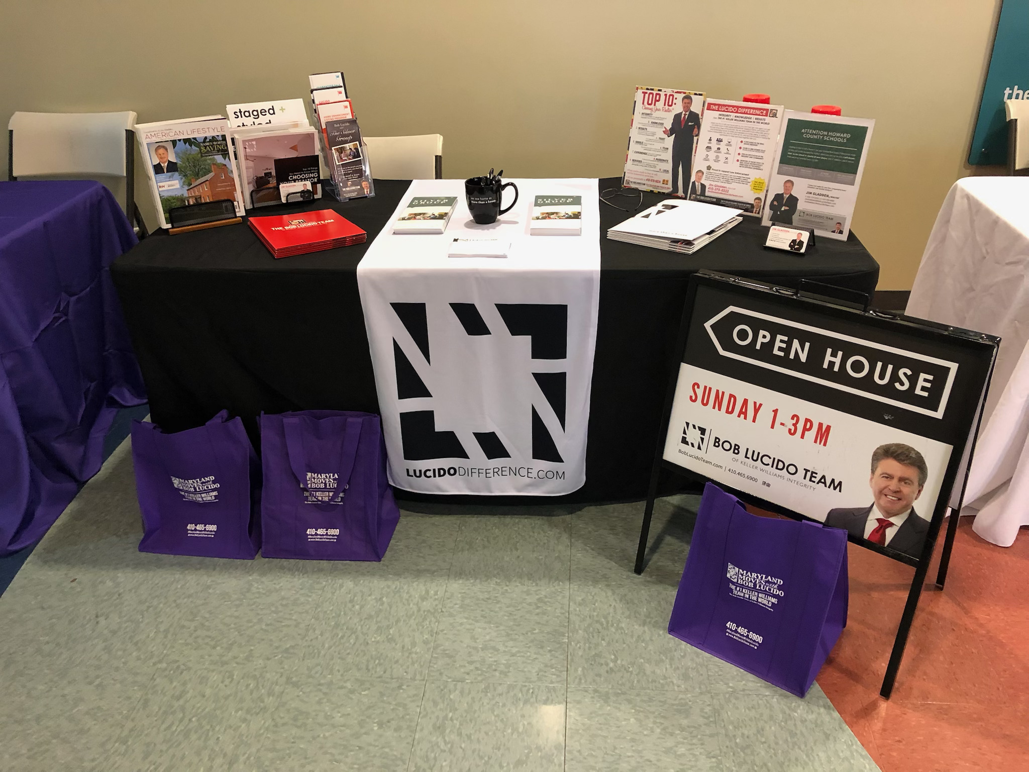Jim Gladden's Bob Lucido Team open house booth setup with marketing materials