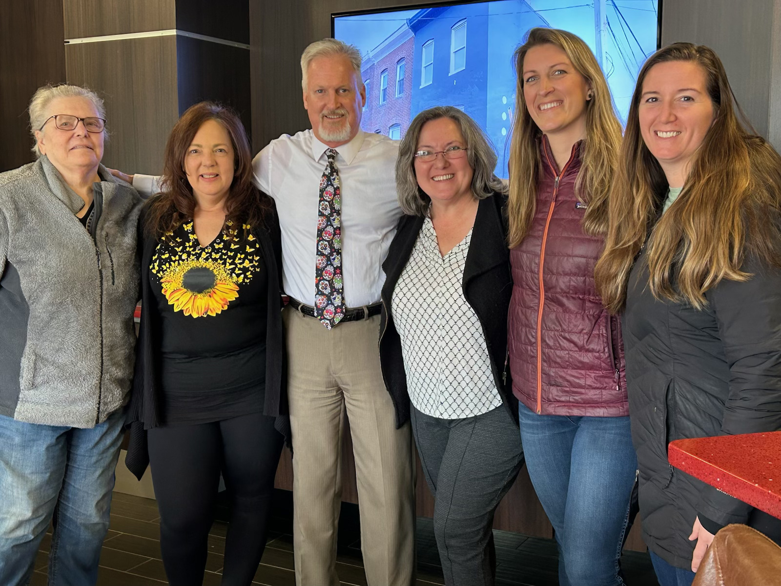 Jim Gladden celebrating with a group of happy clients